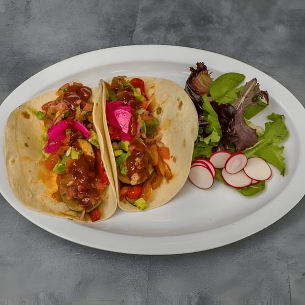 Two Silantro Lime Tacos with salsa, pickled onions, and a side salad with radishes.