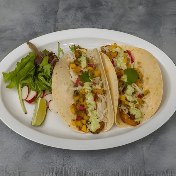 Two Silantro Lime Tacos with mango salsa, green sauce, and a side salad with radishes and lime.