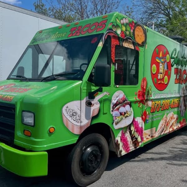 Bright green Silantro Lime Tacos food truck with colorful Mexican-themed graphics parked outdoors.